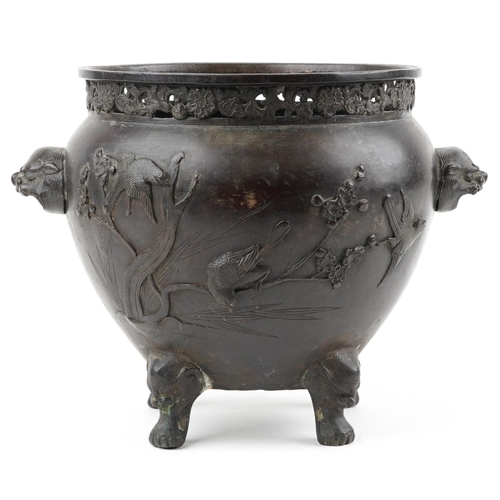 1103 - Japanese patinated bronze four footed jardiniere with pierced border and animalia handles carved in ... 