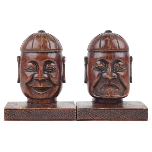 1199 - Pair of Chinese hardwood bookends carved with Buddha heads, each 23cm high