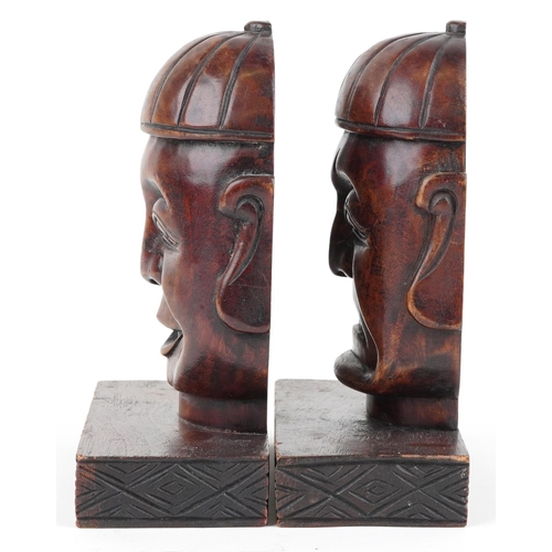 1199 - Pair of Chinese hardwood bookends carved with Buddha heads, each 23cm high