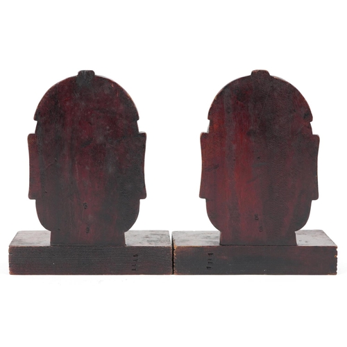 1199 - Pair of Chinese hardwood bookends carved with Buddha heads, each 23cm high