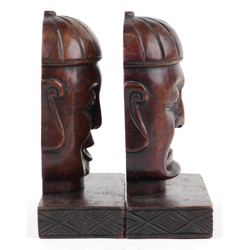 1199 - Pair of Chinese hardwood bookends carved with Buddha heads, each 23cm high