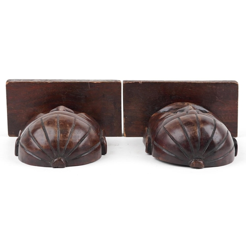 1199 - Pair of Chinese hardwood bookends carved with Buddha heads, each 23cm high