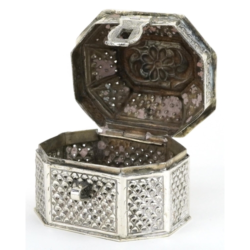 145 - Tibetan silver casket with hinged lid embossed with flowers and foliage, impressed marks to the base... 