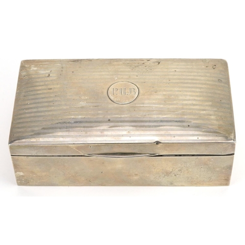 35 - I S Greenberg & Co, George V rectangular silver cigarette box, the hinged lid with engine turned dec... 