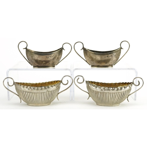 171 - Two pairs of Victorian and later silver open table salts with twin handles, the largest 10.5cm wide,... 