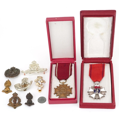 500 - Militaria including Polish Order of the Banner of Work, Cross of Merit Third Class and cap badges