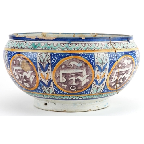 138 - Islamic pottery footed bowl hand painted with calligraphy and flowers, 28cm in diameter