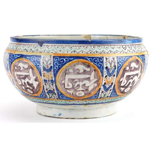 138 - Islamic pottery footed bowl hand painted with calligraphy and flowers, 28cm in diameter