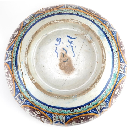 138 - Islamic pottery footed bowl hand painted with calligraphy and flowers, 28cm in diameter