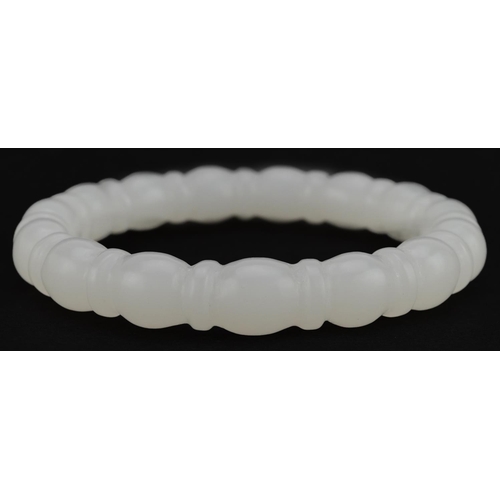 2090 - Chinese carved white jade bangle, 8cm in diameter, 45.5g