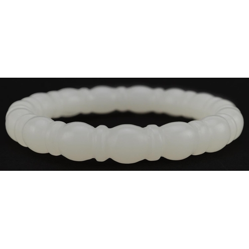 2090 - Chinese carved white jade bangle, 8cm in diameter, 45.5g