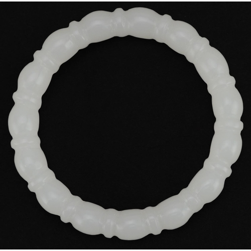 2090 - Chinese carved white jade bangle, 8cm in diameter, 45.5g