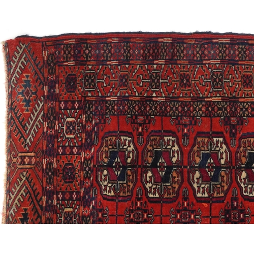 1085 - Rectangular Bukhara red and blue ground rug having an allover geometric design, 116cm x 88cm