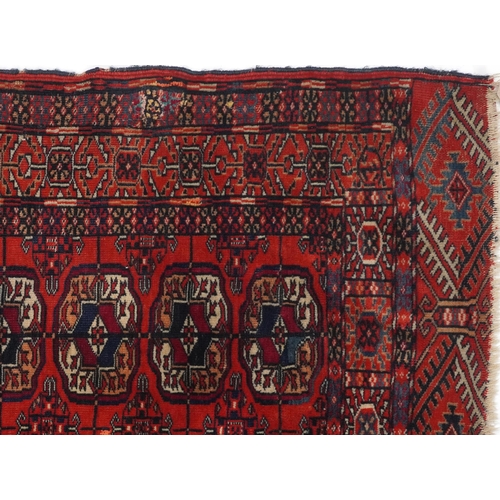 1085 - Rectangular Bukhara red and blue ground rug having an allover geometric design, 116cm x 88cm