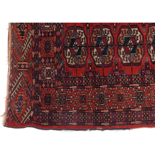 1085 - Rectangular Bukhara red and blue ground rug having an allover geometric design, 116cm x 88cm