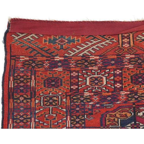 1085 - Rectangular Bukhara red and blue ground rug having an allover geometric design, 116cm x 88cm