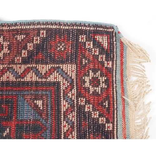 1086 - Turkish Red and blue ground carpet runner having an allover repeat geometric design, 295cm x 75cm