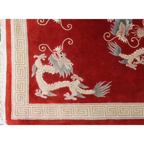 1071 - Chinese red and cream carpet decorated with dragons chasing the flaming pearl and Greek key border, ... 