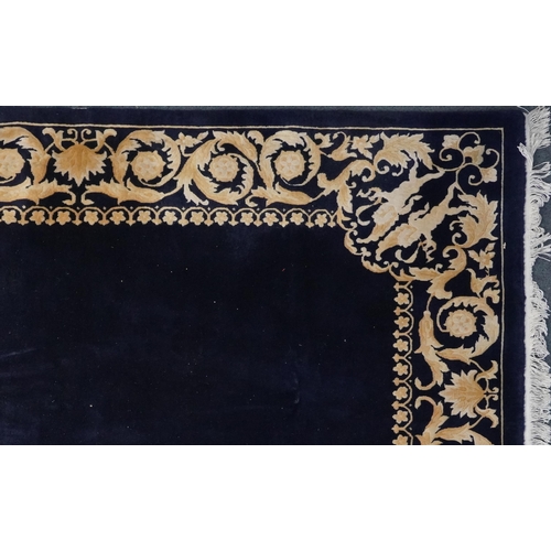 1047 - Large rectangular blue ground rug having a cream and gold floral and Putti design border, 

250cm x ... 