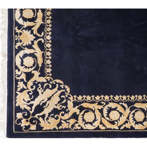 1047 - Large rectangular blue ground rug having a cream and gold floral and Putti design border, 

250cm x ... 