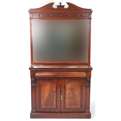 1075 - Victorian mahogany side cupboard with mirrored back above frieze drawer and pair of cupboard doors, ... 