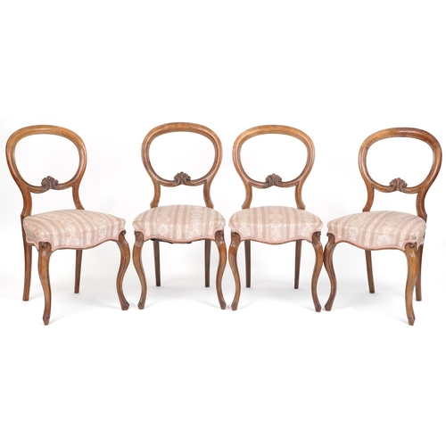 1035 - Set of four Victorian walnut spoon back dining chairs with salmon floral upholstered seats, 87cm hig... 