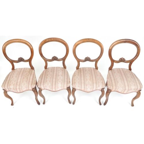 1035 - Set of four Victorian walnut spoon back dining chairs with salmon floral upholstered seats, 87cm hig... 