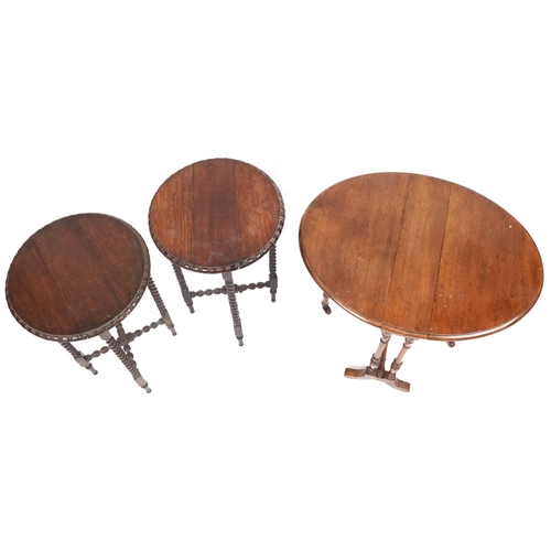 1082 - Three drop leaf tables including a pair of oak barley twist examples, the largest 65cm high