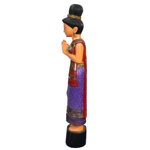 1016 - Thai floor standing carved wood figure of a female wearing a jewelled dress, 128cm high