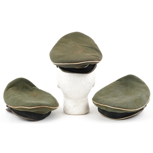 457 - Three German military interest peak caps with badges