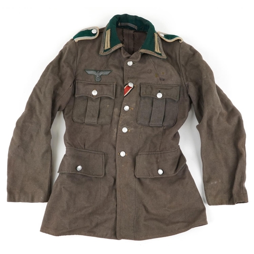 496 - German military interest tunic with cloth badge