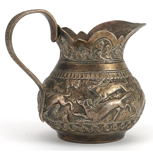 149 - Anglo Indian unmarked silver cream jug embossed with wild animals, 7cm high, 101.8g