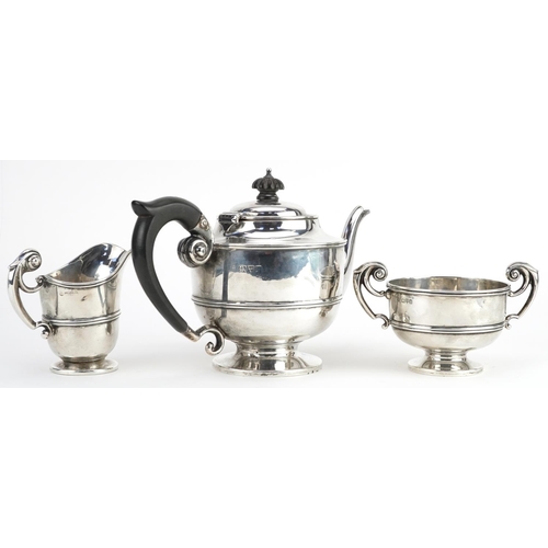 133 - George Nathan & Ridley Hayes, Edwardian silver three piece tea service, the teapot with ebonised woo... 