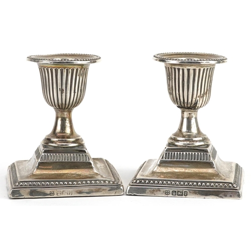 65 - James Deakin & Sons, pair of Edwardian silver urn design dwarf candlesticks, Sheffield 1903, 8.5cm h... 