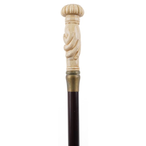 1313 - Hardwood walking stick with carved bone hand design pommel, 90cm in length