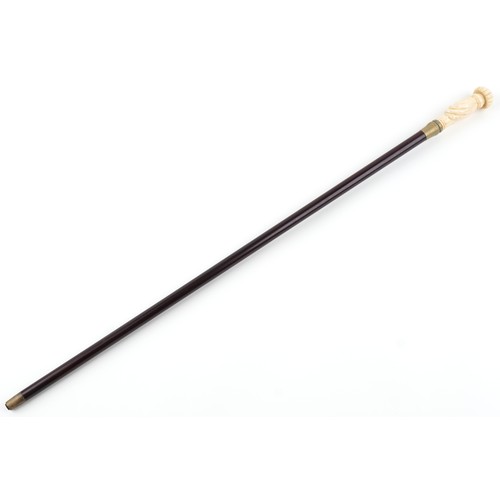 1313 - Hardwood walking stick with carved bone hand design pommel, 90cm in length