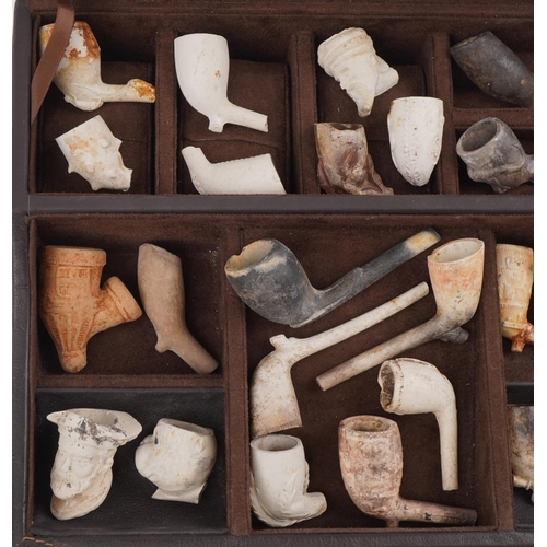 102 - Collection of antique clay or pottery tobacco smoking pipes and bowls including examples in the form... 