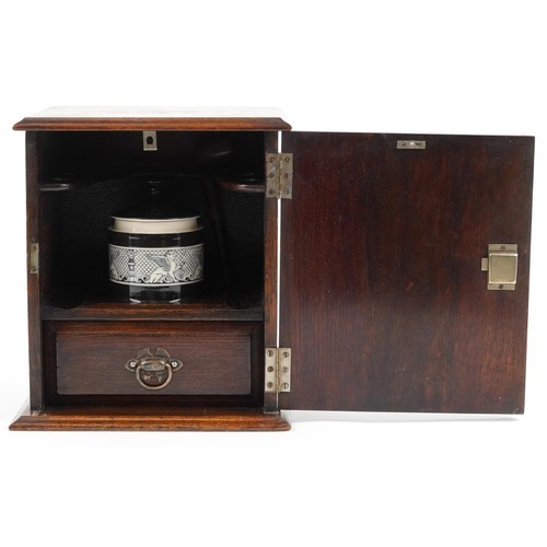 1306 - Oak smoker's cabinet with ceramic tobacco jar and silver plaque engraved British Legion Harome & Dis... 