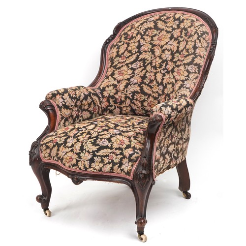 1012 - Victorian mahogany arm chair with floral upholstery and serpentine front, 90cm high