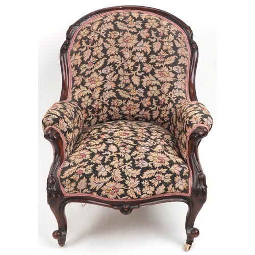 1012 - Victorian mahogany arm chair with floral upholstery and serpentine front, 90cm high