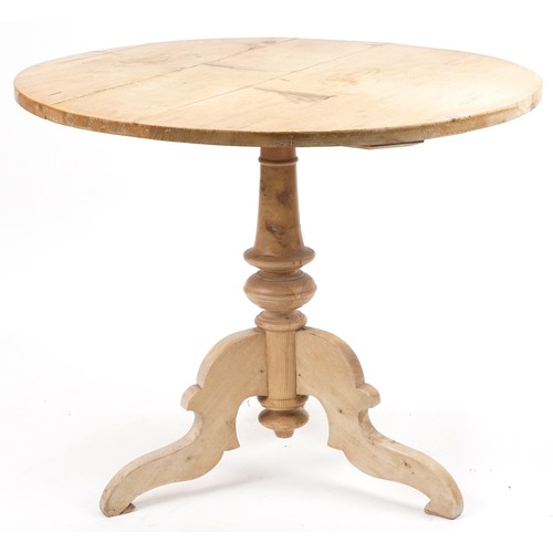 1077 - Victorian stripped pine circular dining table and two chairs, the table 76cm high x 94cm in diameter