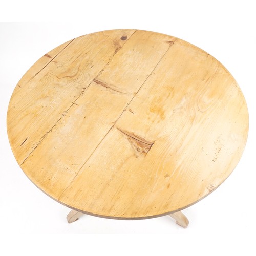 1077 - Victorian stripped pine circular dining table and two chairs, the table 76cm high x 94cm in diameter