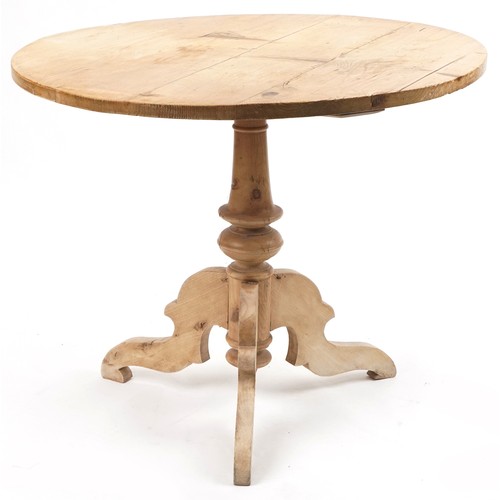 1077 - Victorian stripped pine circular dining table and two chairs, the table 76cm high x 94cm in diameter