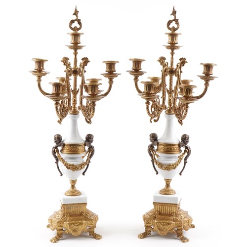 311 - Pair of French style brass and white marble seven branch candelabras, each 69.5cm high