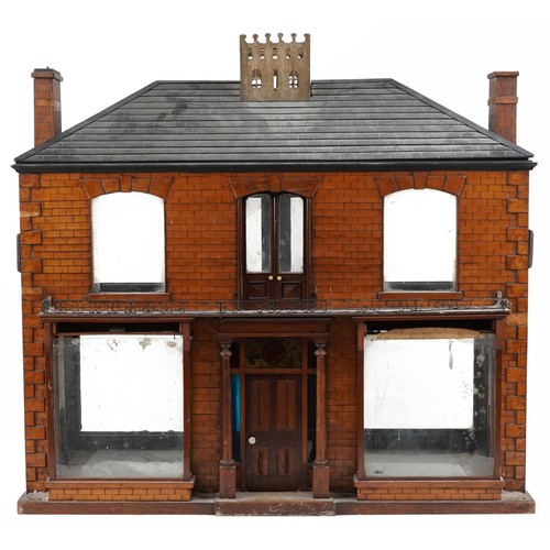 1357 - Large antique scratch built wooden doll's house with various glass panels and brass carrying handles... 