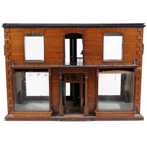 1357 - Large antique scratch built wooden doll's house with various glass panels and brass carrying handles... 