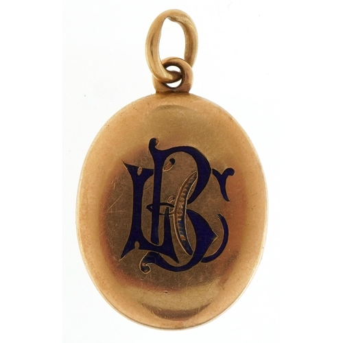 2206 - Victorian unmarked gold oval locket with blue enamel monogram, tests as 15ct gold, 3.8cm high, 9.8g