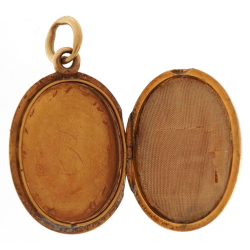 2206 - Victorian unmarked gold oval locket with blue enamel monogram, tests as 15ct gold, 3.8cm high, 9.8g