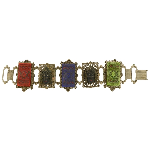 2657 - Thai white metal panelled bracelet with carved busts, 18cm in length, 77.0g