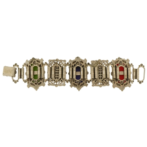 2657 - Thai white metal panelled bracelet with carved busts, 18cm in length, 77.0g